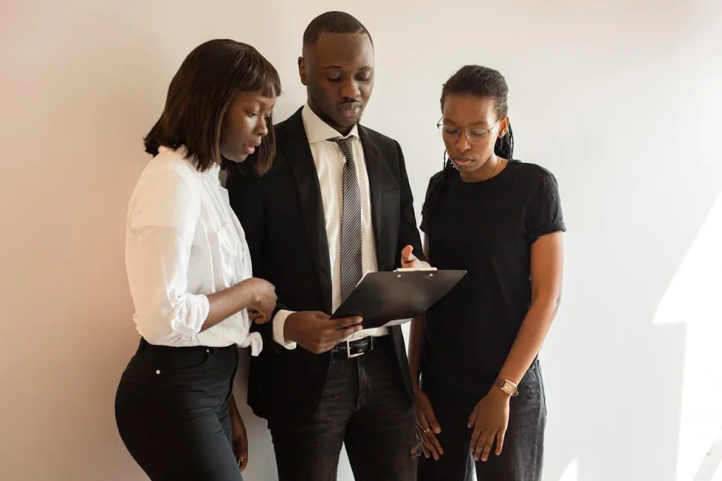 Professionals reviewing onboarding goals and discussing first-month priorities for a new employee